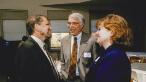 Pat Dobel chatting with faculty members